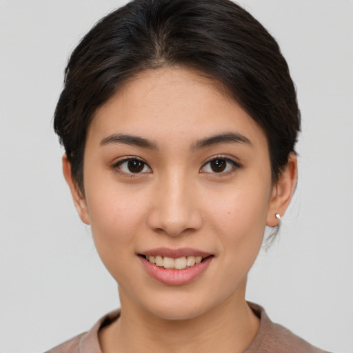 Joyful asian young-adult female with short  brown hair and brown eyes