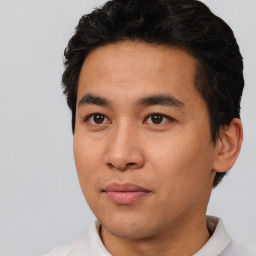 Joyful asian young-adult male with short  black hair and brown eyes