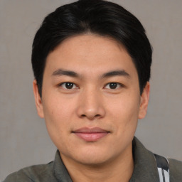 Joyful asian young-adult male with short  black hair and brown eyes