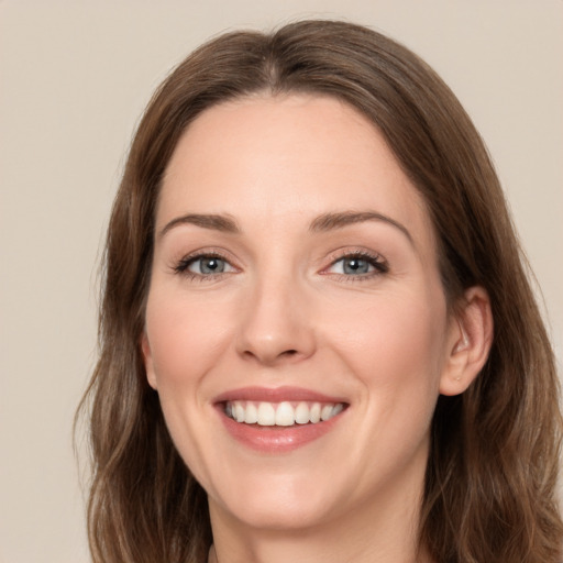 Joyful white young-adult female with medium  brown hair and green eyes