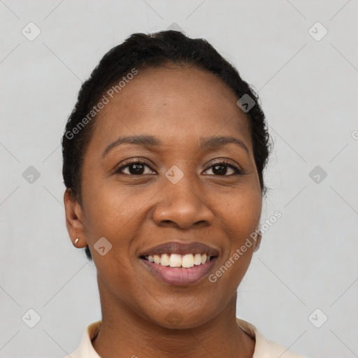 Joyful black young-adult female with short  black hair and brown eyes