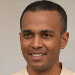 Joyful latino adult male with short  brown hair and brown eyes