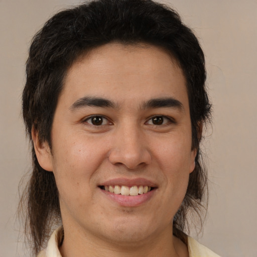 Joyful latino young-adult male with medium  brown hair and brown eyes