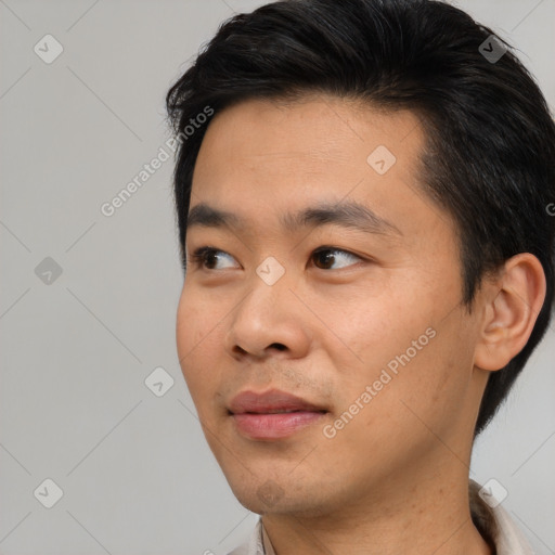 Joyful asian young-adult male with short  black hair and brown eyes