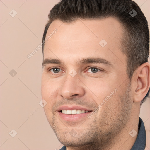 Joyful white young-adult male with short  brown hair and brown eyes