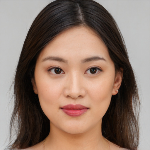 Joyful asian young-adult female with medium  brown hair and brown eyes