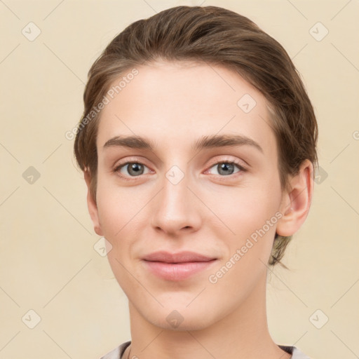 Joyful white young-adult female with short  brown hair and grey eyes