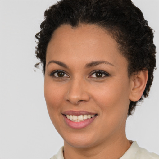 Joyful latino young-adult female with short  brown hair and brown eyes