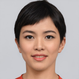 Joyful asian young-adult female with short  black hair and brown eyes