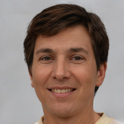 Joyful white adult male with short  brown hair and brown eyes