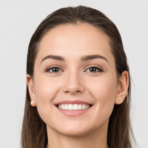 Joyful white young-adult female with long  brown hair and grey eyes