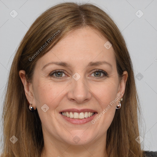 Joyful white adult female with long  brown hair and grey eyes