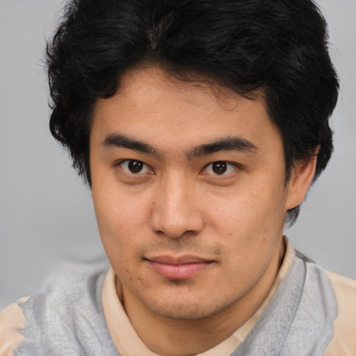 Joyful latino young-adult male with short  brown hair and brown eyes