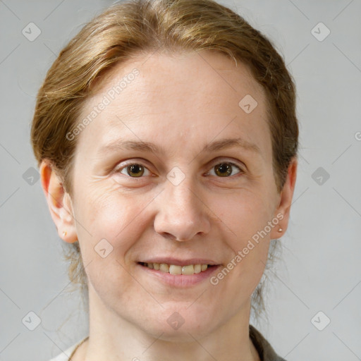 Joyful white adult female with medium  brown hair and grey eyes