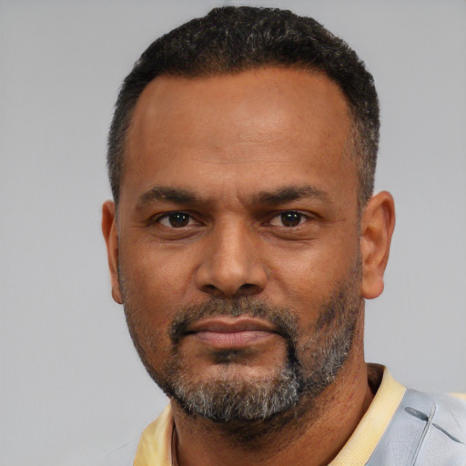 Neutral latino adult male with short  black hair and brown eyes