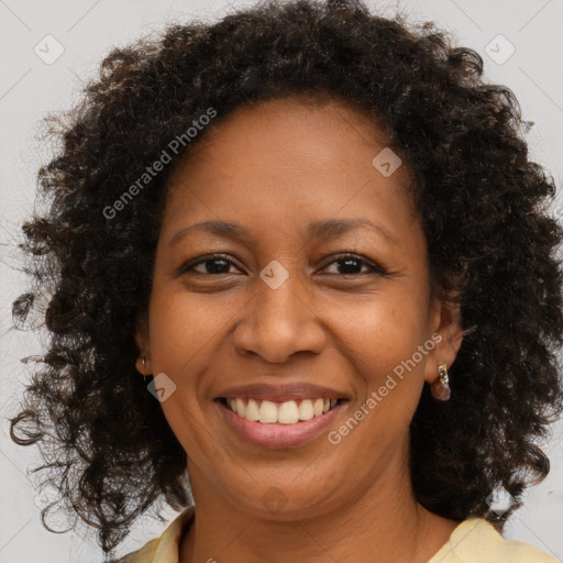 Joyful black adult female with medium  brown hair and brown eyes