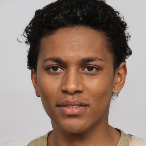Joyful black young-adult male with short  black hair and brown eyes