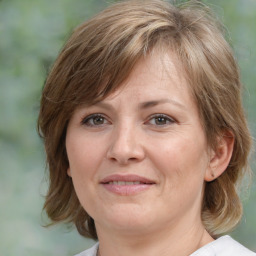 Joyful white adult female with medium  brown hair and brown eyes