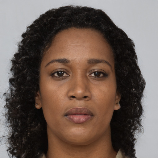 Neutral black young-adult female with long  brown hair and brown eyes