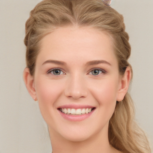 Joyful white young-adult female with long  brown hair and blue eyes