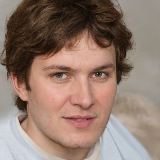 Joyful white adult male with short  brown hair and blue eyes