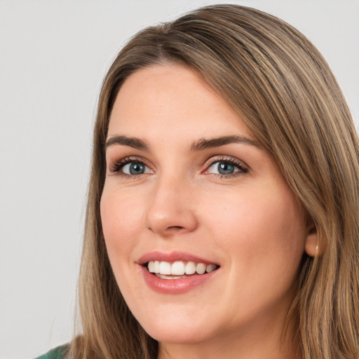 Joyful white young-adult female with long  brown hair and green eyes