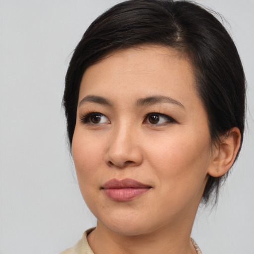 Joyful asian young-adult female with medium  brown hair and brown eyes