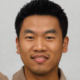 Joyful asian young-adult male with short  black hair and brown eyes