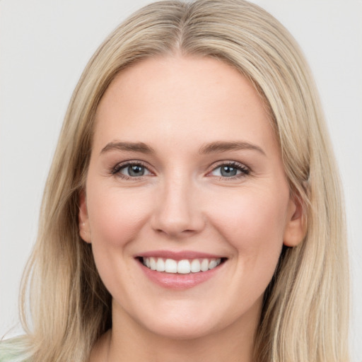 Joyful white young-adult female with long  brown hair and blue eyes