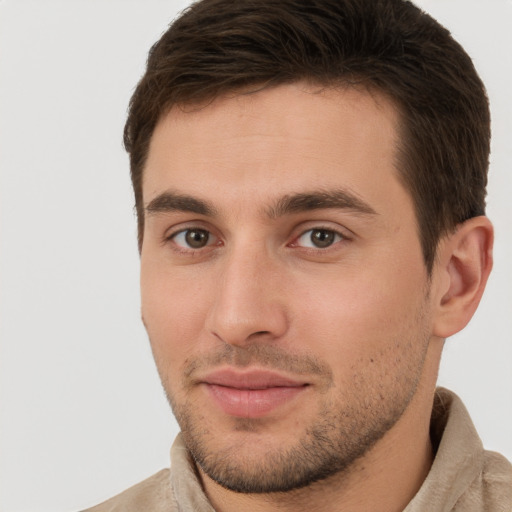 Joyful white young-adult male with short  brown hair and brown eyes