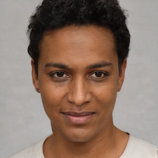 Joyful black young-adult male with short  black hair and brown eyes