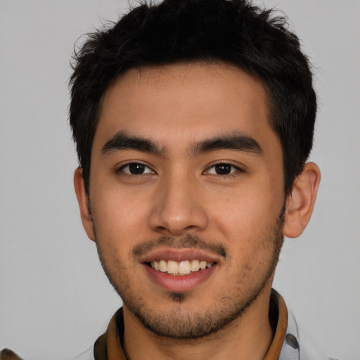 Joyful latino young-adult male with short  brown hair and brown eyes