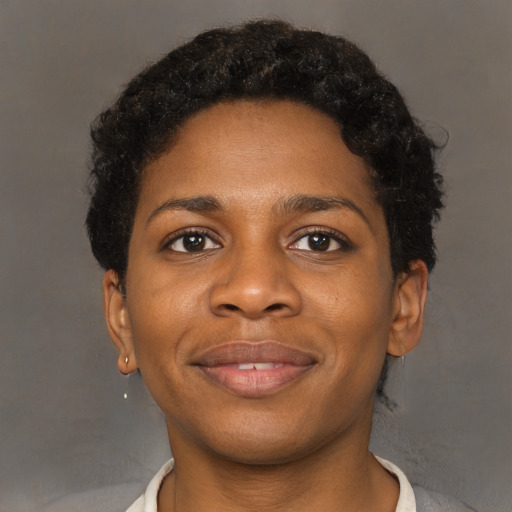 Joyful black young-adult female with short  brown hair and brown eyes
