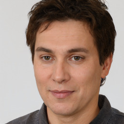 Joyful white adult male with short  brown hair and brown eyes