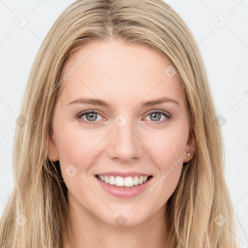 Joyful white young-adult female with long  brown hair and blue eyes