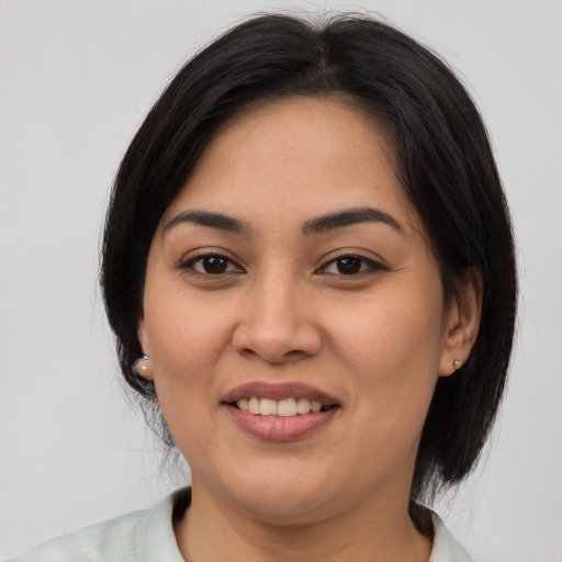 Joyful asian young-adult female with medium  black hair and brown eyes