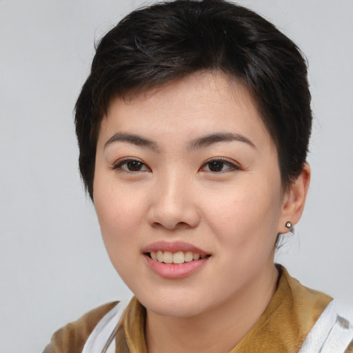Joyful asian young-adult female with short  brown hair and brown eyes