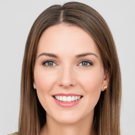 Joyful white young-adult female with long  brown hair and green eyes