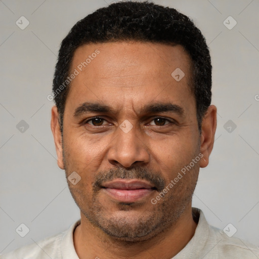 Joyful latino adult male with short  black hair and brown eyes