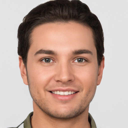 Joyful white young-adult male with short  brown hair and brown eyes