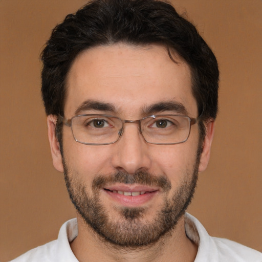 Joyful white young-adult male with short  black hair and brown eyes