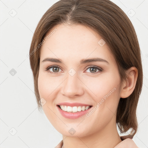 Joyful white young-adult female with medium  brown hair and brown eyes