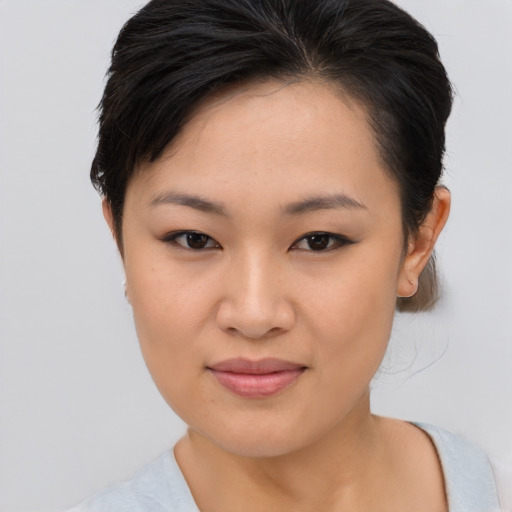 Joyful asian young-adult female with short  brown hair and brown eyes