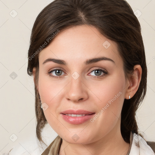 Joyful white young-adult female with medium  brown hair and grey eyes