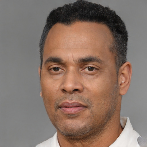 Neutral latino adult male with short  black hair and brown eyes
