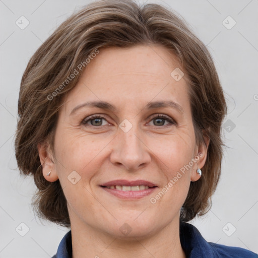 Joyful white adult female with medium  brown hair and grey eyes