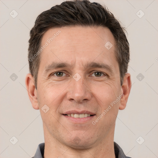 Joyful white adult male with short  brown hair and brown eyes