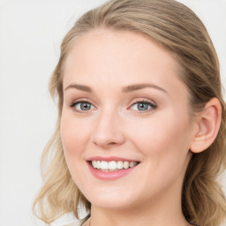 Joyful white young-adult female with long  brown hair and blue eyes