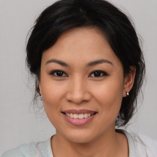 Joyful asian young-adult female with medium  brown hair and brown eyes