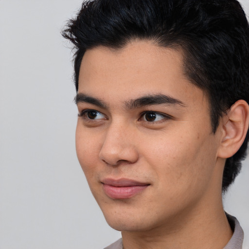 Joyful asian young-adult male with short  brown hair and brown eyes